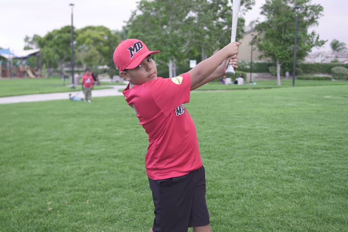 MAD Dawgs player pointing bat at camera