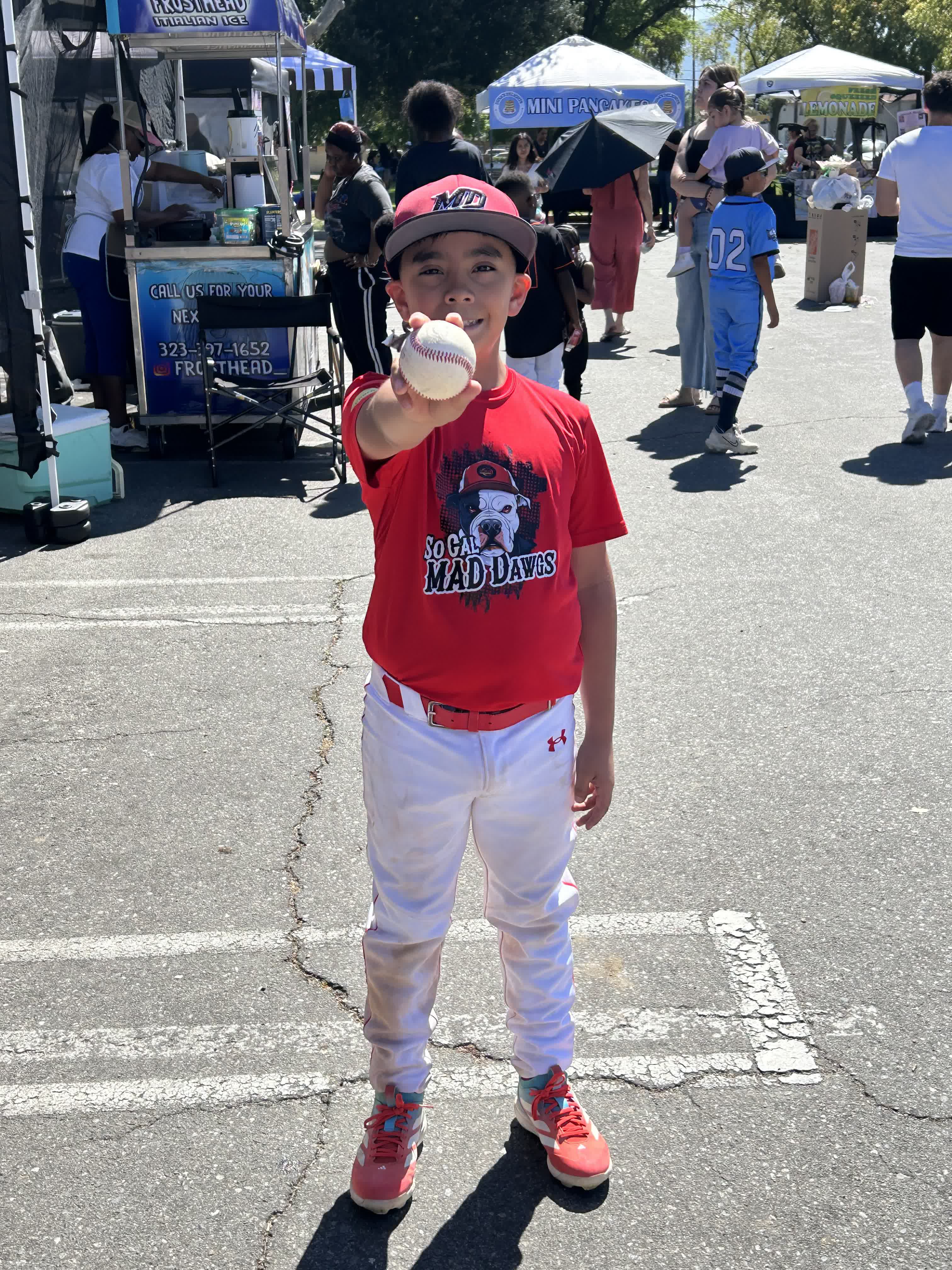 MAD Dawgs player holding baseball at event