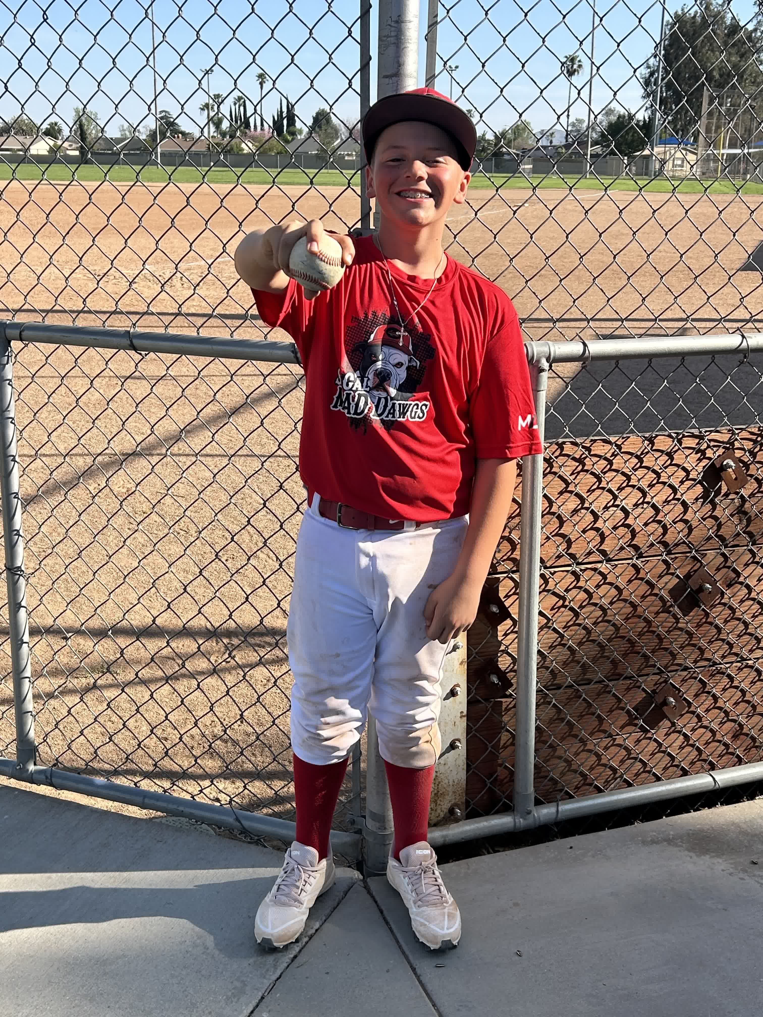 MAD Dawgs player at the dugout fence