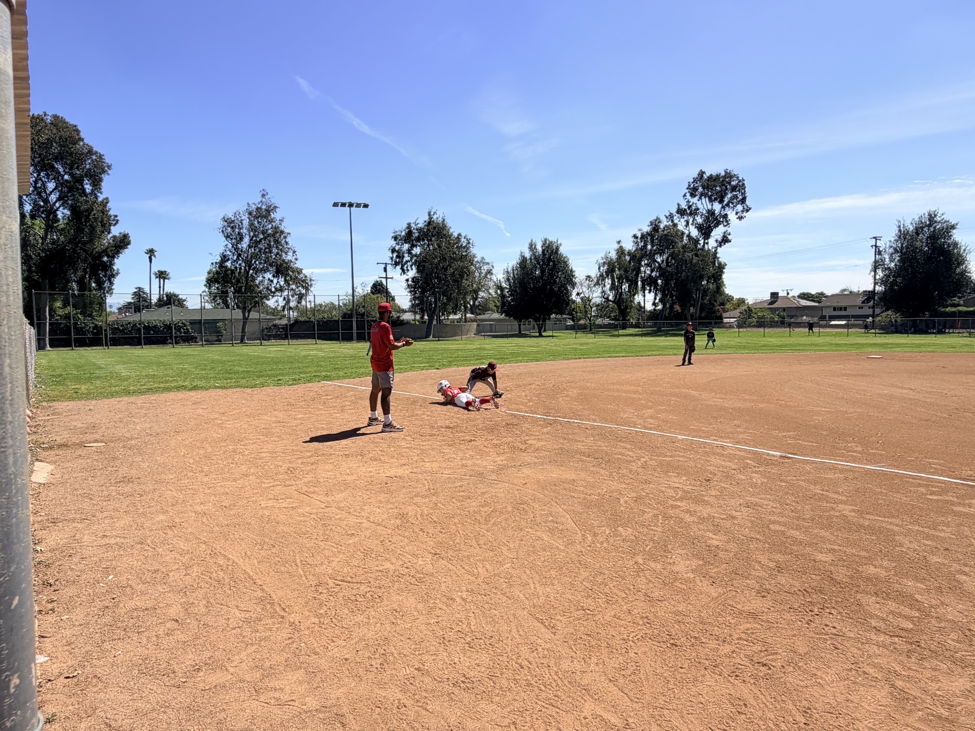 MAD Dawgs player sliding headfirst into a base