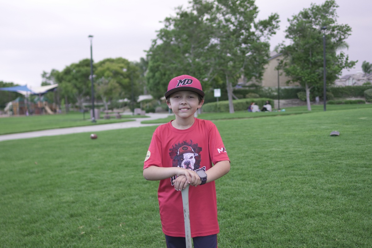 MAD Dawgs player with bat and cap