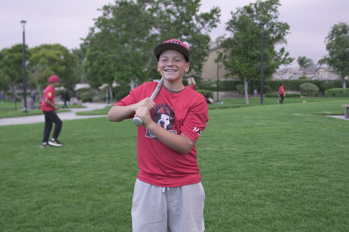 MAD Dawgs player with huge grin and bat