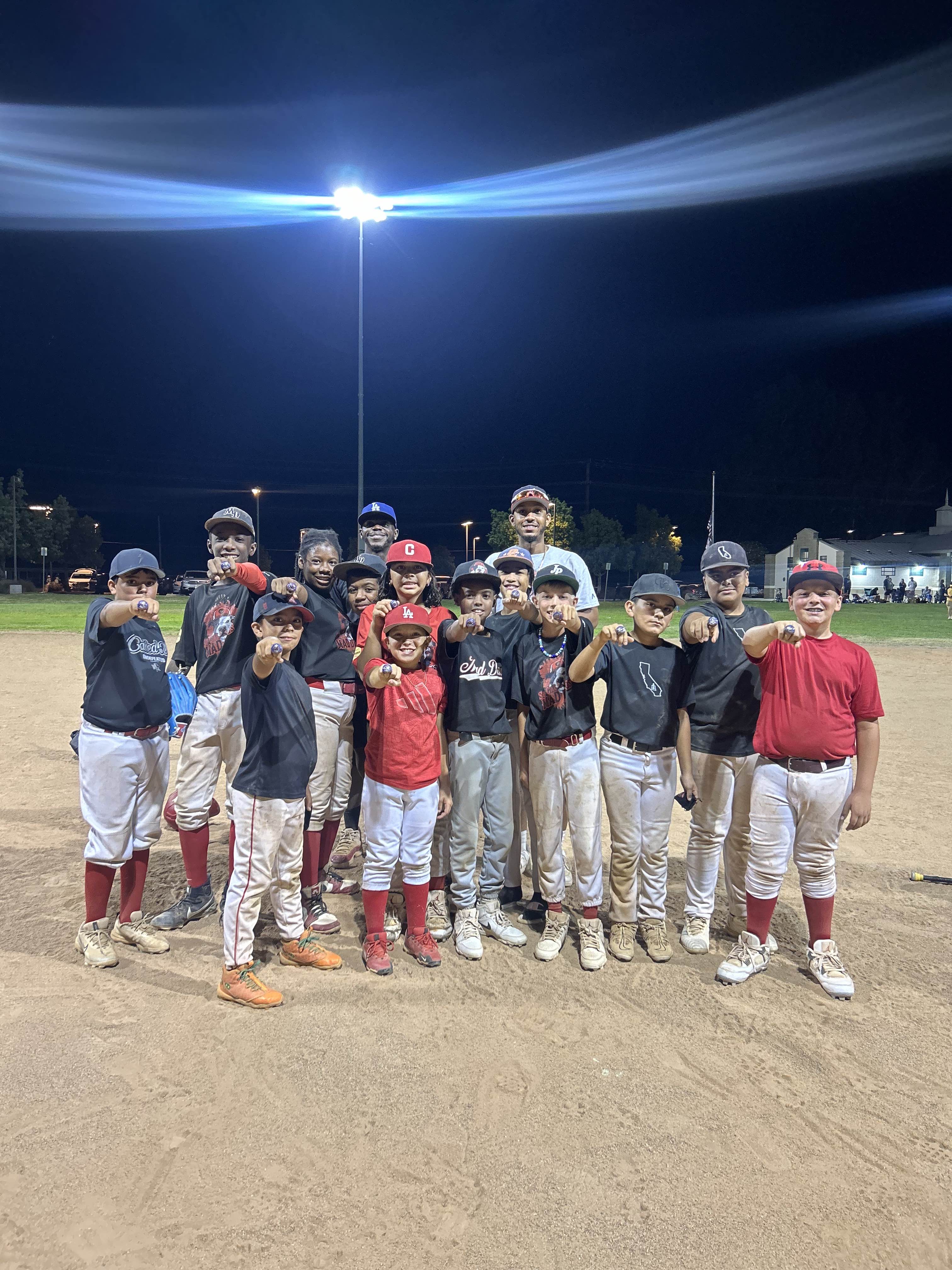 MAD Dawgs team showing championship rings at night game